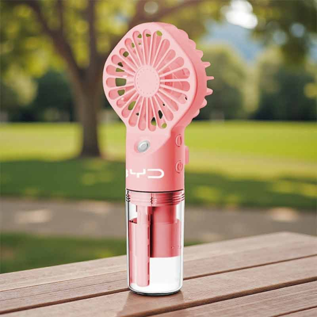 Handheld misting fan providing cooling spray and airflow for outdoor events